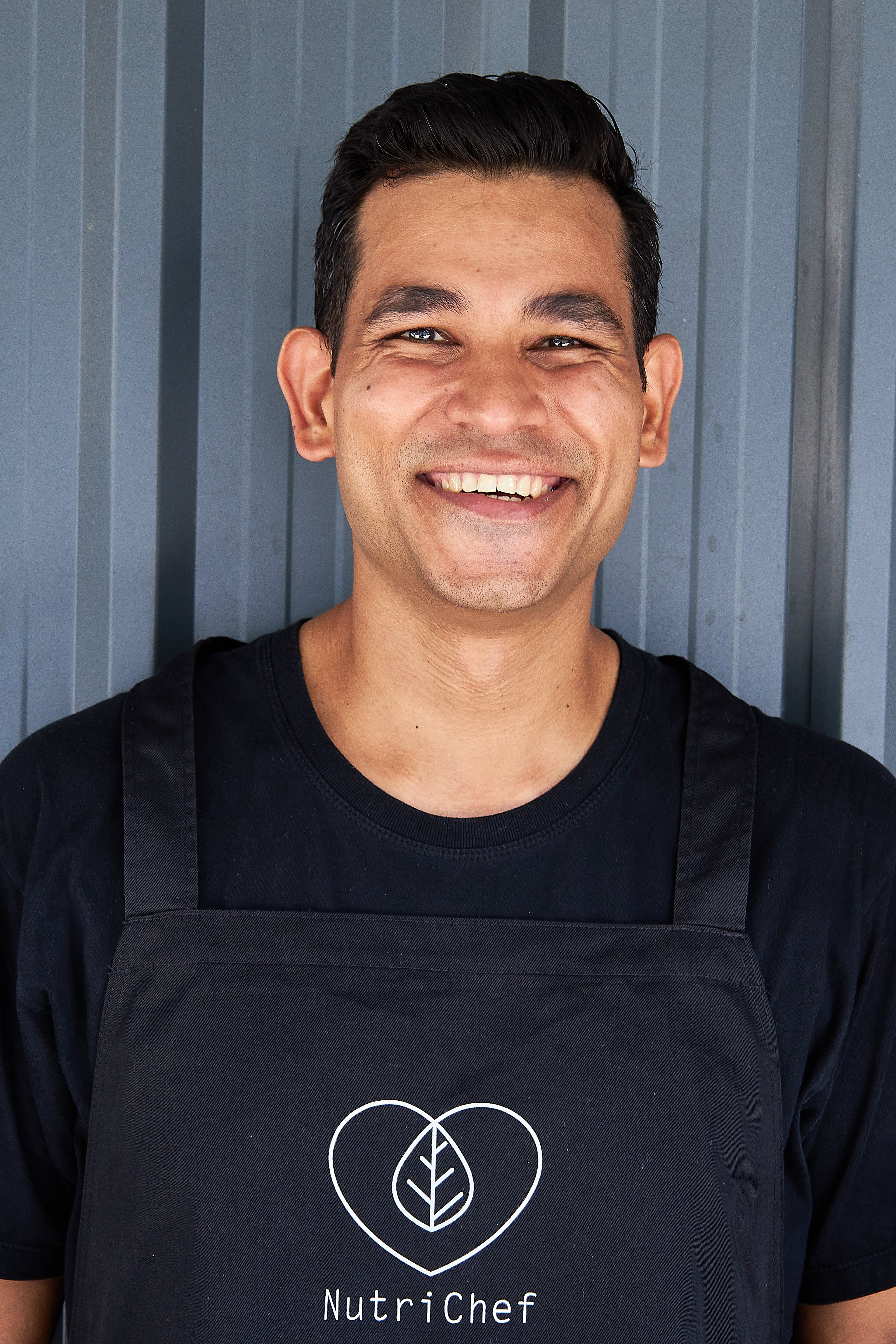 Nutrichef  Carlton Pereirain, The Founder of Nutrichef in Bangkok, wearing a branded apron, represents healthy meal delivery and expert diet planning services.